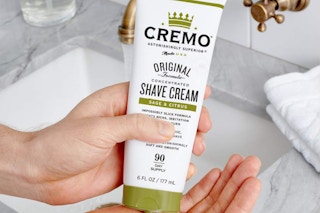 Cremo Shave Cream 2-Pack being held over sink
