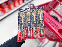 hand holding colgate harry potter electric toothbrushes at target