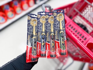 hand holding colgate harry potter electric toothbrushes at target