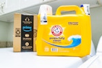 Arm & Hammer detergent next to Prime box on laundry machine