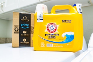 Arm & Hammer detergent next to Prime box on laundry machine
