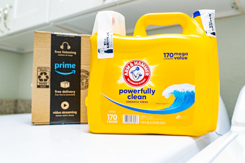 Arm & Hammer detergent next to Prime box on laundry machine