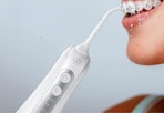 white water flosser being used on a woman with braces