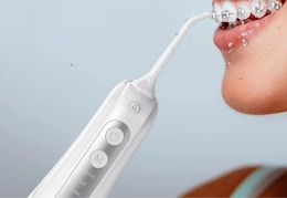 white water flosser being used on a woman with braces