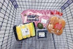 corn, blueberries, pork ribs, avocado, and hamburger buns in a cart