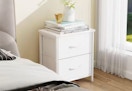 white 2-drawer night stand next to a window and bed