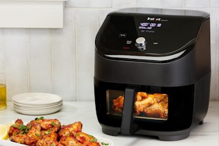 An Instant Pot Vortex air fryer near food on a counter.