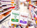 2 happy coffee canisters sitting on top of groceries in a target aisle