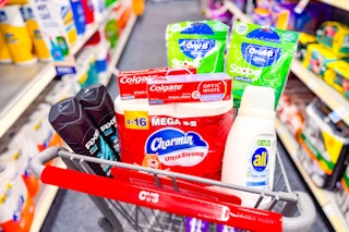 axe body wash, charmin toilet paper, colgate toothpaste, all detergent, and oral b floss picks in a cart