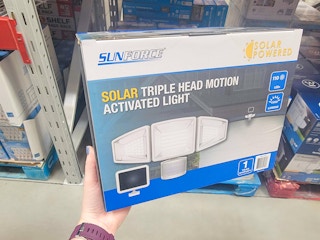hand holding a solar triple head motion activated light