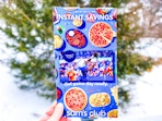 hand holding sams club february instant savings book