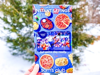 hand holding sams club february instant savings book