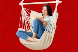 Woman siting in large beige hammock chair swing 