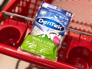 A pack of Dentek flossers in a cart.