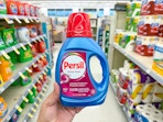 hand holding persil detergent in walgreens