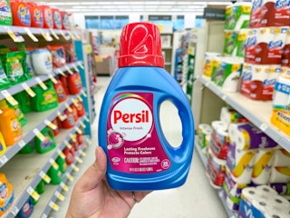 hand holding persil detergent in walgreens