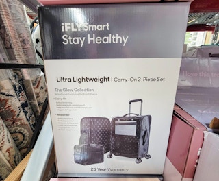 box with a black 2 piece luggage set in it