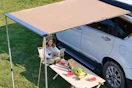 a woman sitting under an awning