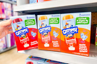 person grabbing a box of gerber get ems squeezies off the shelf