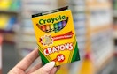 hand holding Crayola crayons