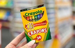 hand holding Crayola crayons