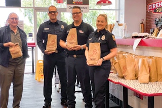 police officers holding up firehouse subs bags 