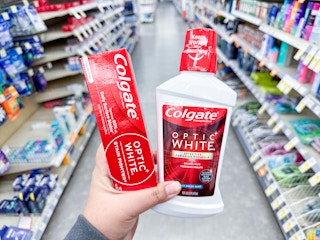 hand holding colgate products in walgreens
