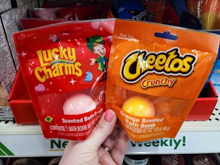 hand holding lucky charms & cheetos bath bombs