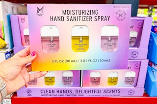 hand holding members mark hand sanitizer spray set
