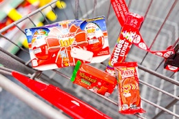 kinder joy, reeses trees, twix, and skittles candy in a cart