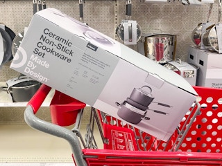 A Ceramic non-stick cookware set sitting in a cart.