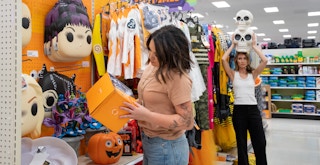 Two people shopping the Halloween section at Target
