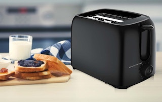 a toaster next to a plate of toast and a glass of milk