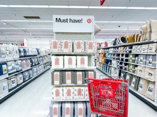 target cart parked in front of sheet sets sitting on a shelf