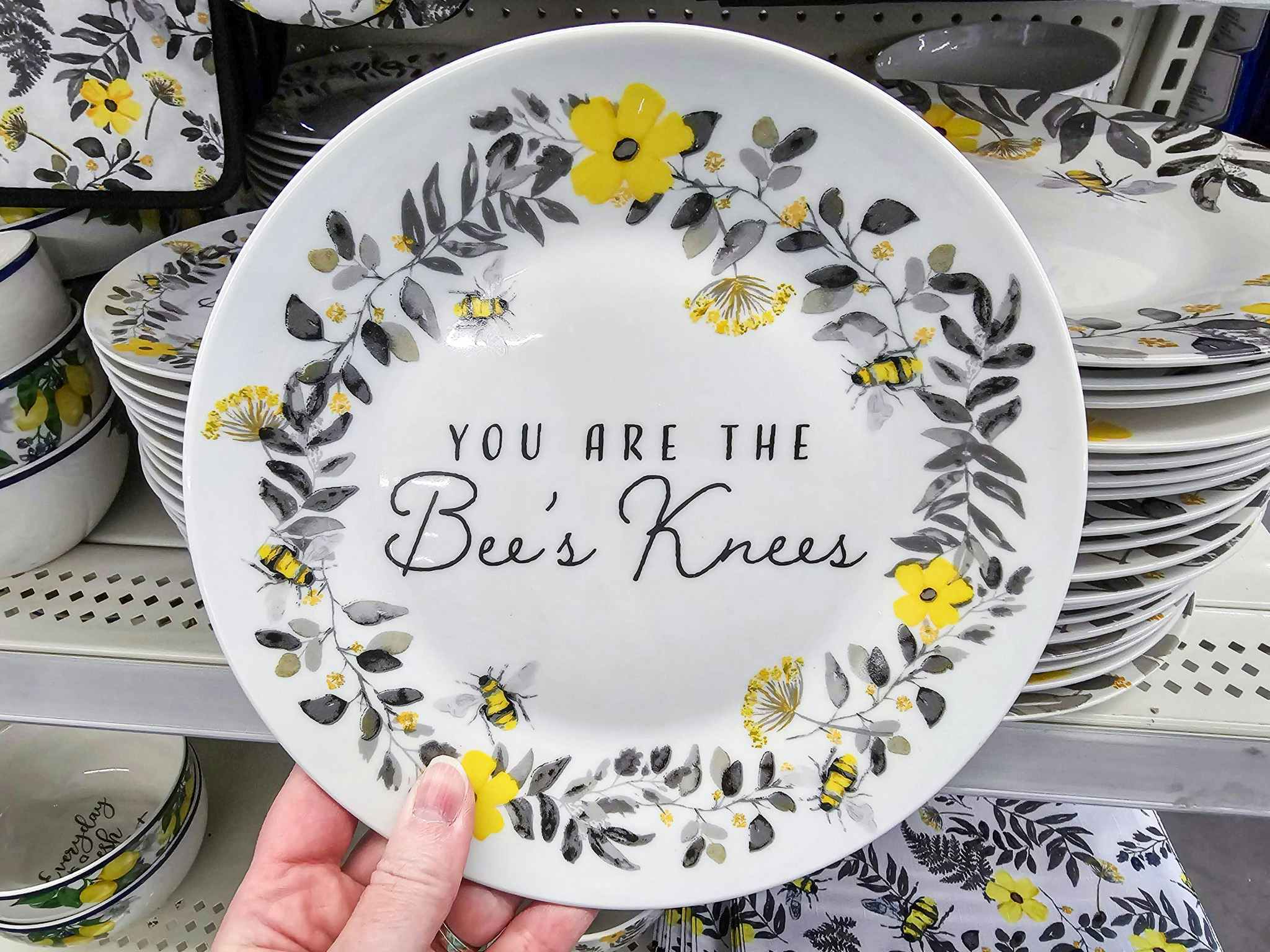 person holding a plate that says "you are the bee's knees"