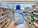 hand holding snuggle liquid fabric softener in walgreens