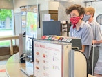 A young Chick-fil-a employee at the ordering counter