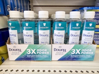 shelf with bottles of downy rinse and refresh