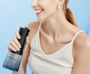 a woman using a water flosser