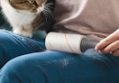 a person using a lint roller on their pants