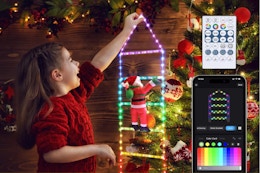 Girl hanging the Toodour Christmas Decorations Lights, 3.3ft Smart RGB Christmas Decorative Lights with Santa Claus.
