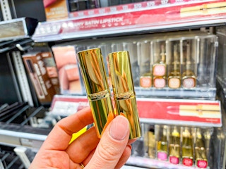 hand holding loreal lipsticks in walgreens