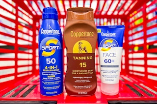 coppertone sunscreen spray face and tanning lotion in a red shopping basket