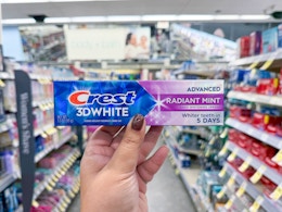 hand holding crest toothpaste in walgreens
