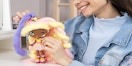 A young girl playing with a Candylocks Lacey Lemonade doll.