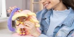 A young girl playing with a Candylocks Lacey Lemonade doll.