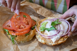A sandwich with lots of extra vegetables.