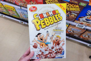 hand holding a box of post cereal
