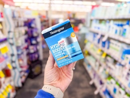 person holding neutrogena hydro boost moisturizer in an aisle