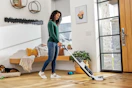 a woman using a bissell vacuum